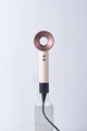 Bladeless hair dryer with beige handle and bronze nozzle on professional stand - Ceramic Pink