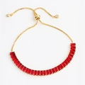Detail of gold adjustable slider bracelet featuring vibrant red rectangular gemstones - Bracelet