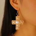 Cross-shaped gold metal earrings with multiple white pearls on female model - Gold Earrings (Pearl Cross A-1311)