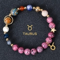 Detailed close-up of a Taurus natural stone beaded bracelet with gold zodiac charm - Taurus