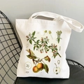 White canvas tote bag featuring vintage apple botanical print on a mesh chair - Apple Botany Print (STD344-I)