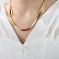 Macro shot of Bohemian handmade beaded necklace with colorful beads on model neckline - Red White Yellow Green Ethnic Beaded / 38+5cm