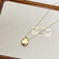 Macro shot of minimalist gold perfume bottle pendant with high-shine mirror finish - Small Flask / Gold
