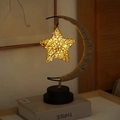 Hemp rope wrapped LED moon and star lamp with warm yellow light on a black base - Rattan Star Moon