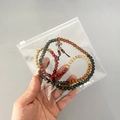 Transparent PVC ziplock jewelry bag containing colorful wooden prayer beads and pendant - Slider Bag 15*15cm