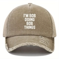 Detail of distressed khaki trucker hat featuring I'M BOB DOING BOB THINGS white text - One Size / Khaki