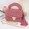Close-up of handmade pink crochet crossbody bag with gold lock and tassel detail - 20*6*15cm / Watermelon red