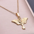Macro shot of 18k gold butterfly and moon pendant necklace on pink satin background - Gold Color Pendant Necklace