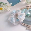 Plush organza hair scrunchie with blue and white daisy embroidery in 45-degree view - 1043C Milky Blue Organza Daisy Embroidery