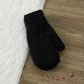Solid black wool knit mittens for winter, shown on rustic wood and white plush background - One Size / Black