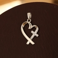 Close-up of a silver heart-shaped cross pendant with micro-pave zircons and star texture - Pendant Only (No Chain) / Silver Heart
