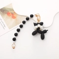 Chic black balloon dog pendant with white pearls and gold metal clasp on white background - Black Balloon Dog