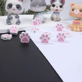 Macro shot of cute pink and white paw-shaped wooden beads for DIY pet jewelry making - Pink Double-Sided Paw Print
