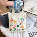 Beige canvas tote bag featuring colorful cartoon floral patterns and summer lettering - Romance and Flowers