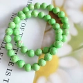 Detailed view of 8mm green cat eye stone beads with natural mottled marble texture - Imitation Regal Stone Fruit Green
