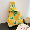 Chic cream knitted handbag featuring yellow tulip floral patterns and a single top handle - Yellow Tulip