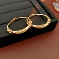 Macro shot of gold twisted hoop earrings with micro-set yellow rhinestones details - Twisted Hoop (32mm) / Gold