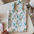 Detail of floral cotton handbag showing the copper button closure and green leaf pattern - White Base Oil Painting Green Grey Flower(T-14)