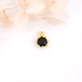 Detailed view of 18k gold plated crown pendant with black zircon stone on white background - Black