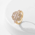 Close-up of a gold hexagonal ring with clear zircon stones on a white stand - Style 7 / Gold