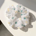 White scrunchie with yellow and cyan floral patterns under natural sunlight - Cream Polka Dot