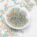 Macro shot of turquoise and amber frosted glass beads for jewelry making in a shell bowl - 8mm Dawn/Mixed Gradient