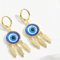 Macro detail of gold evil eye earrings featuring blue accents and three gold leaf tassels - Sapphire Blue
