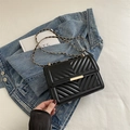 Classic black quilted crossbody bag with gold chain strap and elegant metallic lock - Black