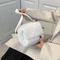 White faux shearling crossbody bag with adjustable fabric strap and magnetic closure - White
