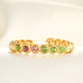 Macro detail of adjustable gold ring featuring multi-colored micro-pave zircons on white silk - Adjustable Open / 18K Gold Colorful Zircon Circular Pattern