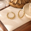 Detail of beaded gold heart earrings on textured fabric with a warm elegant background - Round Hoop Beaded (ZHE482金)
