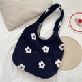 Detailed macro view of fuzzy navy blue underarm tote bag with white embroidered flowers - Flower Navy Blue