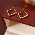Minimalist golden square hoop earrings with smooth metallic finish on leather box - Minimalist Gold Rectangular Geometric Hoop Earrings