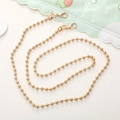 Detailed view of the shiny golden metal bead chain lanyard with secure lobster clasps - 6mm Gold Ball Chain