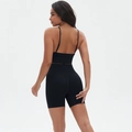 Detail view of high-waist scrunch yoga shorts and thin strap sports bra set in black - S / Black