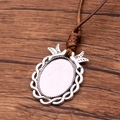 Antique silver oval pendant base with brown PU cord and decorative wing details - Wing Decoration Textured Style