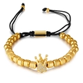 Golden beaded bracelet with crown charm, clear crystals, and black braided cord - Gold