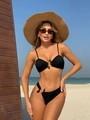 Detail of black ribbed bikini with decorative resin rings against a beach background - S / Black