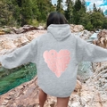 Grey hoodie with pink Love Yourself heart print worn by a model in nature setting - Light Gray