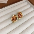 Detail view of vintage amber resin heart earrings with a gold irregular metal frame - Arched Irregular (9#) / Gold Amber