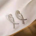Silver criss-cross earrings with inlaid zirconia on a white silk background - Silver Crossed Rhinestone Earrings
