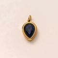 Close-up of a blue teardrop birthstone pendant set in 18k gold plated stainless steel - September Birthstone Pendant (Sapphire)