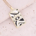 Close-up of golden rectangular Virgin Mary pendant with enamel eye pattern and crystals - Black White Eye Abstract Rectangle (11#)