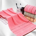 Detailed texture of colorful cotton towels with ribbed edges in a metal storage basket - 32x70cm / Rose