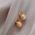 Elegant champagne pearl earrings with gold circular hooks on grey silk background - Champagne