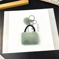 Portachiavi mini borsa in peluche verde pastello con anello metallico e pompon soffice - Confezione in busta singola OPP / Verde