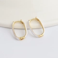Minimalist U-shaped oval gold earrings with white enamel finish in a sleek design - White