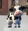 Vache noire et blanche avec cornes dorées (Style Douze)