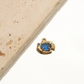 Detailed close-up of 18K gold plated fish pendant with blue gemstone on white stone - 3# Fish Light Blue Zircon