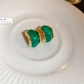 Close-up of vintage emerald green resin earrings with gold plating on ceramic tray - Green C-Shape